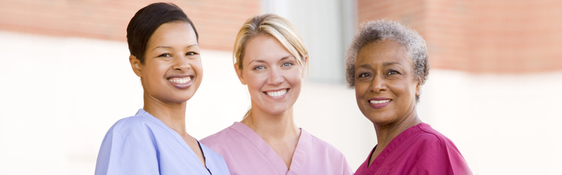 three smiling female caregivers
