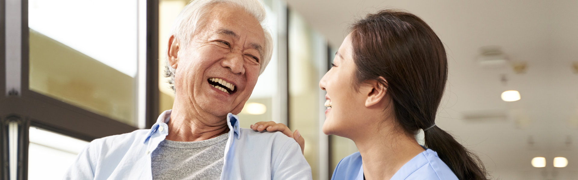 smiling caregiver with senior man